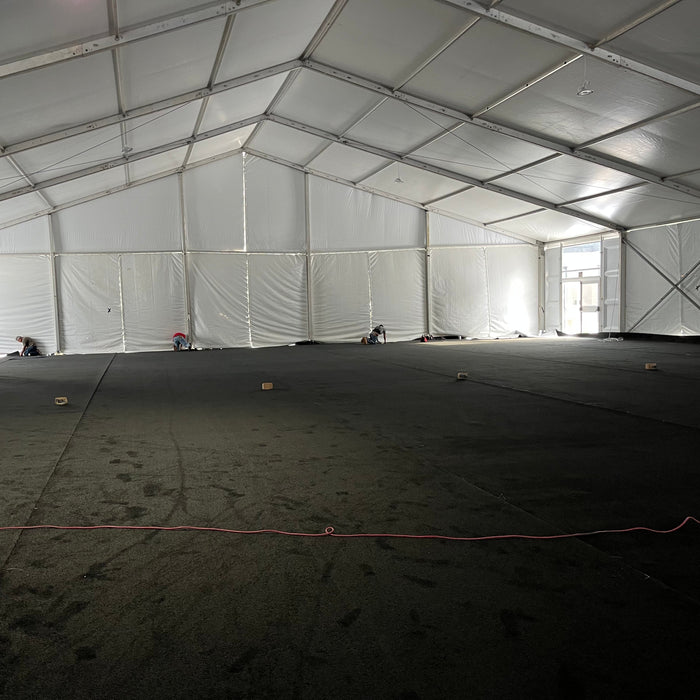 Black Event Carpet installed inside of a large structure tent with side walls