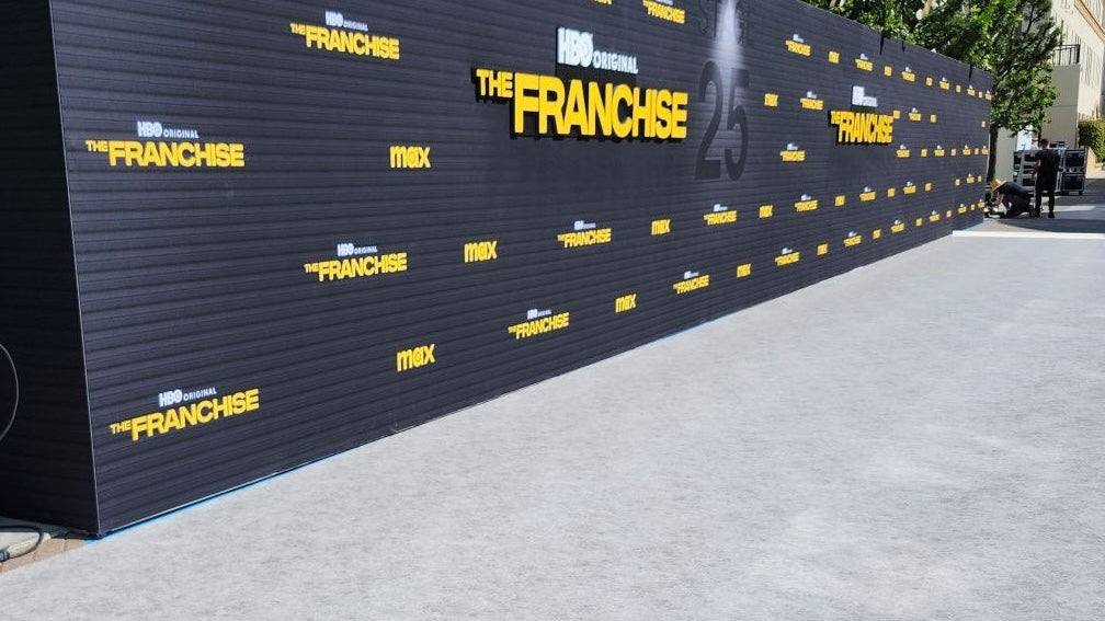 HBO original 'The Franchise' promotional wall, black with yellow text, outdoor event backdrop.