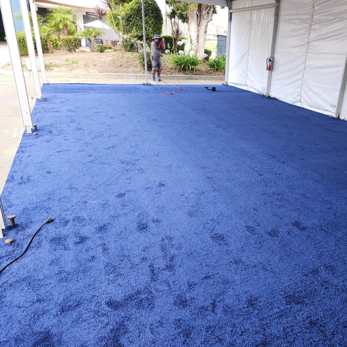Soft blue carpet flooring in a tent setup, ideal for events and gatherings.